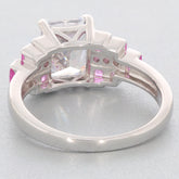 Back view of elegant Emerald White Moissanite ring with pink accent stones set in sterling silver.